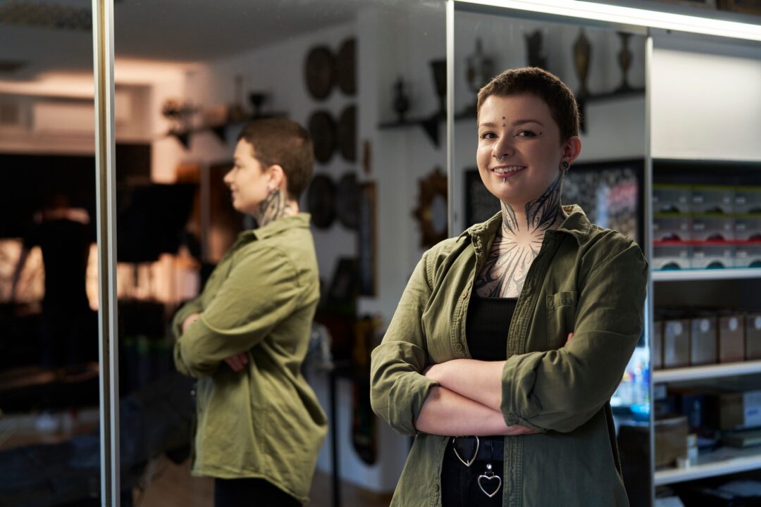 Caucasian female tattoo artist in tattoo studio